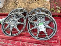 Group of 15 hub caps seen from an angle, showing their metallic structure and design.