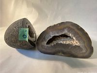 Photo of sliced open geode showing banded patterns in gray and brown and crystalline center.