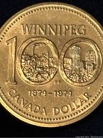 Reverse image of 1974 Canadian dollar coin commemorating Winnipeg 100th anniversary