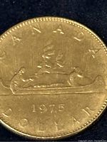 Close-up of the reverse side of the 1975 Canadian dollar coin showing the voyageur and indigenous person in a canoe, with the year 1975 and inscriptions visible.