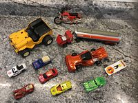 Photo showing all 11 assorted toy cars and trucks on a countertop with good lighting