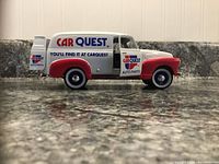 Side view of 1952 Chevy Panel Delivery Car Quest coin bank showing branding and condition.