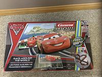 Box of the Carrera Go Cars 2 Race Around The World slot racing set showing Lightning McQueen and Francesco Bernoulli artwork.