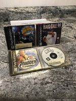 Four used PlayStation 1 sports games displayed showing cases and discs for NFL Street, HardBall 99, Madden 2000, and MLB 99