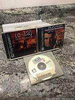 Photo showing three PlayStation 1 games: C-12 Final Resistance and James Bond 007: Tomorrow Never Dies in cases, and Tenchu disc in sleeve.