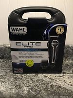Front view of Wahl Elite Pro hair clipper kit box showing product name, image of clipper, and key features including powerful motor, precision blades, corded design.