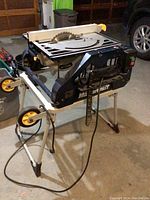Mastercraft table saw on metal stand with wheels and power cord