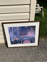 Framed print showing the choir at Worcester Cathedral inside a wooden frame with white matting, photographed against an outdoor background.