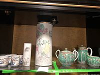 Photo of the full set showing tall decorative vase, four teacups, creamer, sugar bowl, teapot