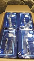 Open box showing four sealed packs of Medline Extendwear briefs, each containing 15 briefs for a total of 60 briefs.