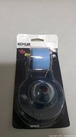 Front view of Kohler K-GP85160 blue flapper with float in original packaging showing product and branding details.