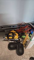 Overview of lot showing circular saw, level, extension cord, knee pads