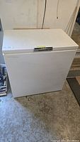 Full view of the white Beaumark chest freezer with closed lid.