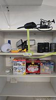 Shelf view showing multiple handheld lights, bucket lights, and a clip-on bench light.