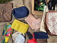 Overview of various bags and pouches arranged on burlap surface