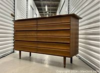 Three-quarter front view of six-drawer dresser showing overall design and finish.