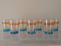 Set of 7 acrylic tumblers with Toronto waterfront, CN Tower and sailboats design, arranged on a shelf.