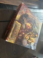 Box of The Hobbit board game showing front and side with character artwork and logos.