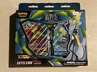 Front view of sealed Inteleon VMAX Battle Deck Pokemon pack showing holographic cards and packaging.