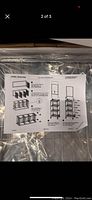 Top view of assembly instructions showing components and assembly steps for metal wire shelving rack with graphics attachments.