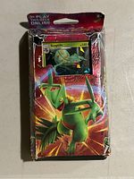 Front view of the sealed booster pack showing Sceptile artwork and visible wear on packaging.