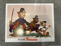 Full view of vintage Pinocchio lobby card showing main characters including Pinocchio and several animals