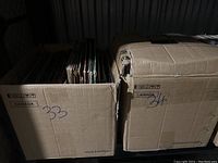 Two cardboard boxes labeled '33' and '34' containing vinyl records.