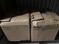 Two large cardboard boxes, labeled 37 and 38, containing mixed vinyl records.