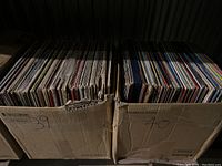 Two cardboard boxes marked 39 and 40 filled with vertically stored vinyl records viewed from above.