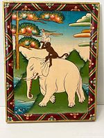 Full view of the framed oil painting showing the elephant, monkey, rabbit, and the decorative border.