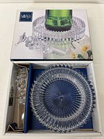 Clear glass Mikasa wine coaster and glass bottle stopper in original box with Mikasa branding and floral decoration on the lid.