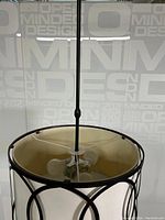 Top inside view of chandelier showing three bulb sockets and metal hanging rod.