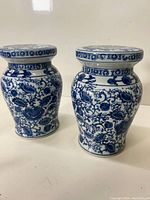 Pair of miniature blue and white Chinese garden stools with floral patterns.