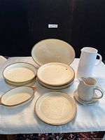 Full set of assorted Canadian pottery and porcelain jugs with oval GOA France plate visible