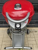 Front view of red Char-Broil Patio Bistro electric barbecue grill on silver gray stand with temperature gauge and dial control visible.