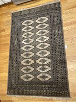 Full view of the Bokhara Superbest Camel Carpet showing central pattern and borders.