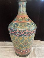 Front view of a tall Moroccan vase with colorful floral and geometric patterns.