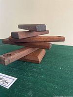 Side view showing stacked horizontal arms of the candleholder on a rectangular base.