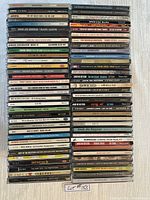Stacked assortment of over 70 blues music CDs showing spine titles for artist and album identification
