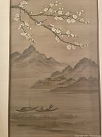 Full view of painted silk panel depicting mountainous landscape, blossoming branch with bird, and boat on water.