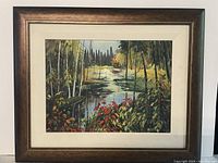 Full view of framed oil on panel painting depicting a fall swamp scene with colorful foliage and water reflection.