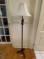 Full view of the standing lamp showing its height and shade.