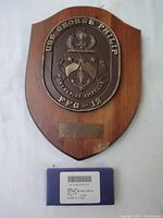 Brass USS George Philip FFG-12 ship plaque featuring detailed crest on wood shield base