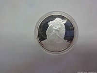 Close-up of the obverse side showing Joe Camel with sunglasses and date 1993, silver round in acrylic case.