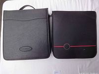Front view of two CD storage cases side by side, one marked Case Logic, the other a black fabric case with red trim.