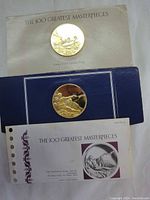 Pair of Franklin Mint commemorative medals with certificates and packaging, displayed on a white surface.