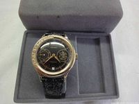 Poljot wristwatch seated in grey suede display case