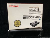 Front view of white Canon box labeled ‘Image Stabilizer 10x30 IS Binoculars’
