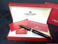 Pen displayed in its original red Caran d’Ache presentation box alongside paperwork and ink cartridge box