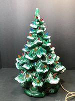 Full front view of unlit ceramic tree showing snow-tipped branches and molded bulb sockets